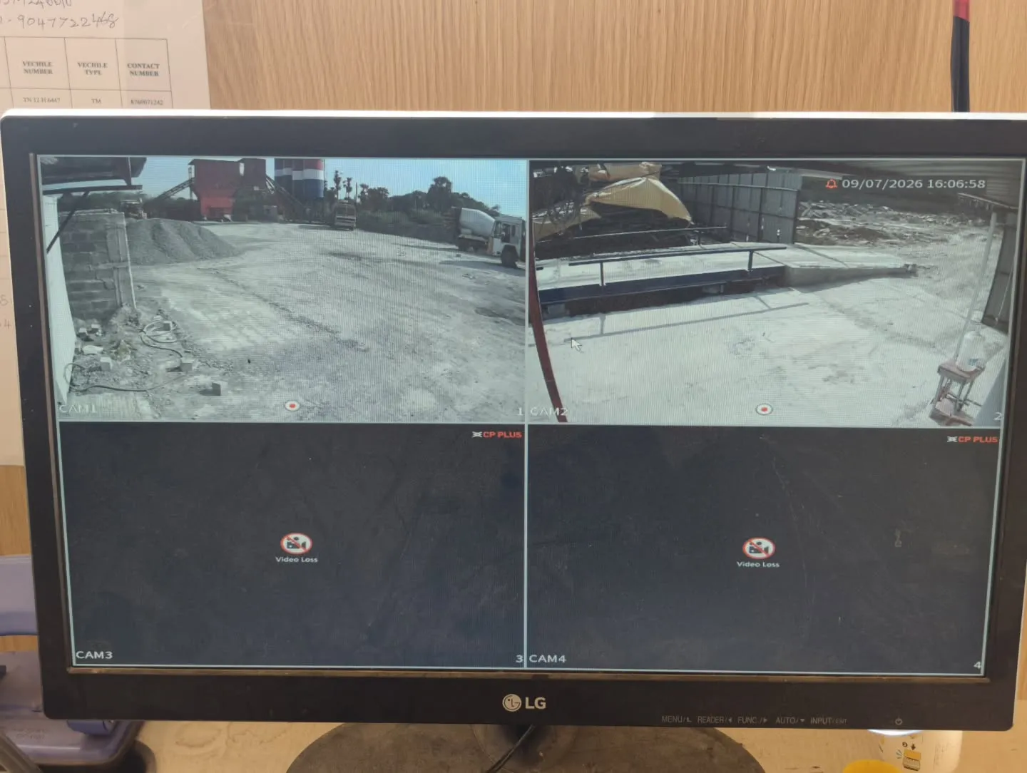 ​An LG monitor displaying crisp, wide-angle live feeds captured by CP Plus Dual Light bullet cameras covering the open industrial yard and processing machinery.