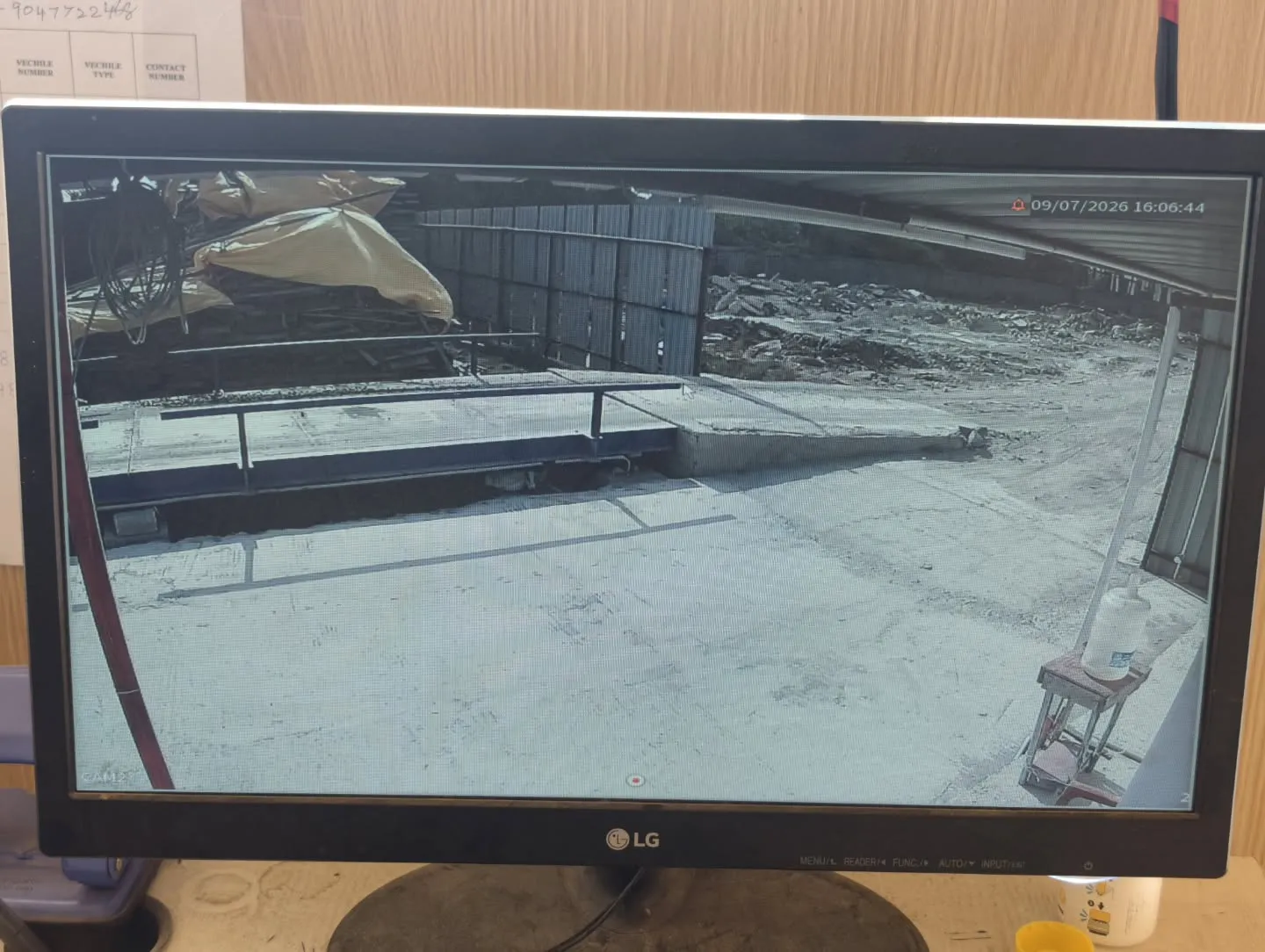 A clear, glare-resistant screen feed from a CP Plus outdoor bullet camera monitoring an industrial loading ramp and vehicle transit path.