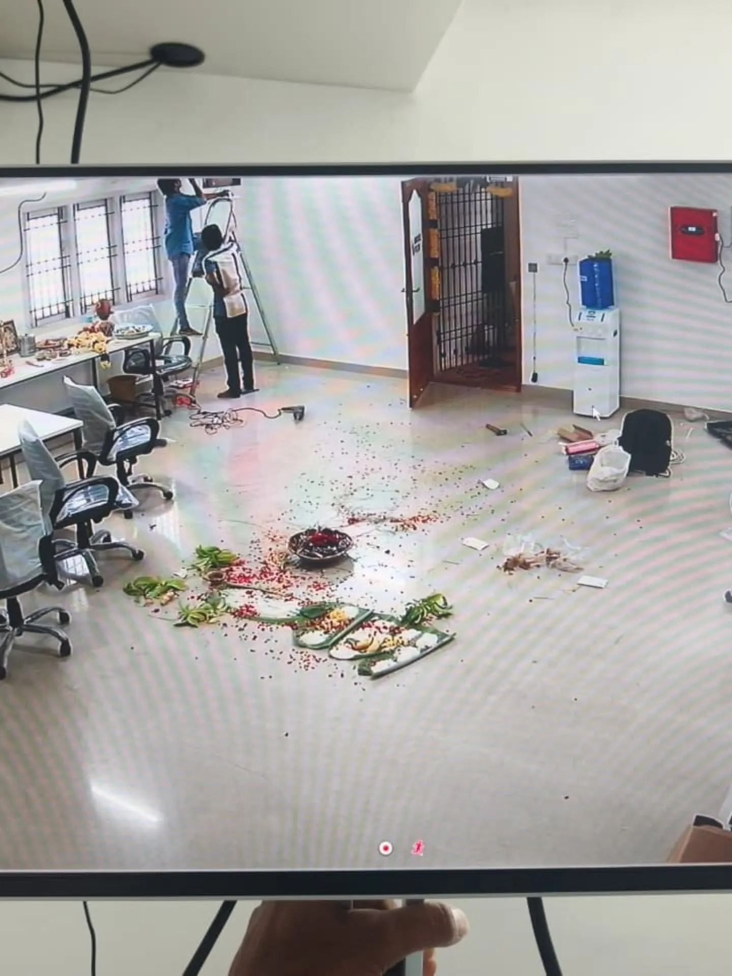 ​A high-angle interior security camera view tracking office setup progress, workstations, and network cabling layouts.