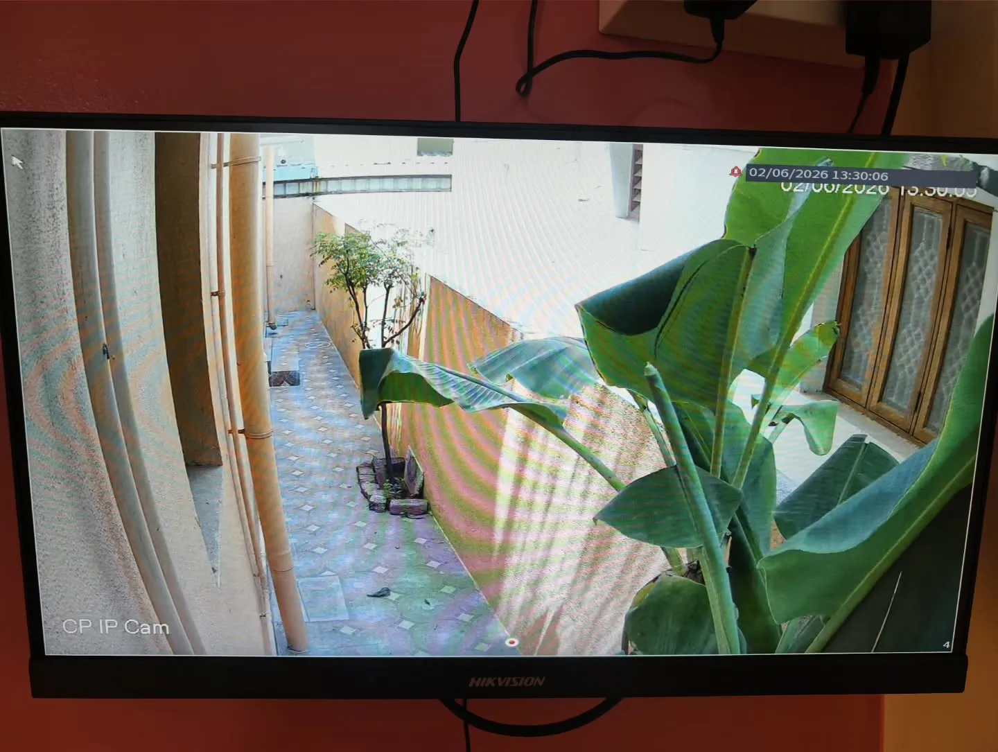 Narrow-angle view from a CP Plus 4MP STQC IP camera installation monitoring a residential building's outdoor passage