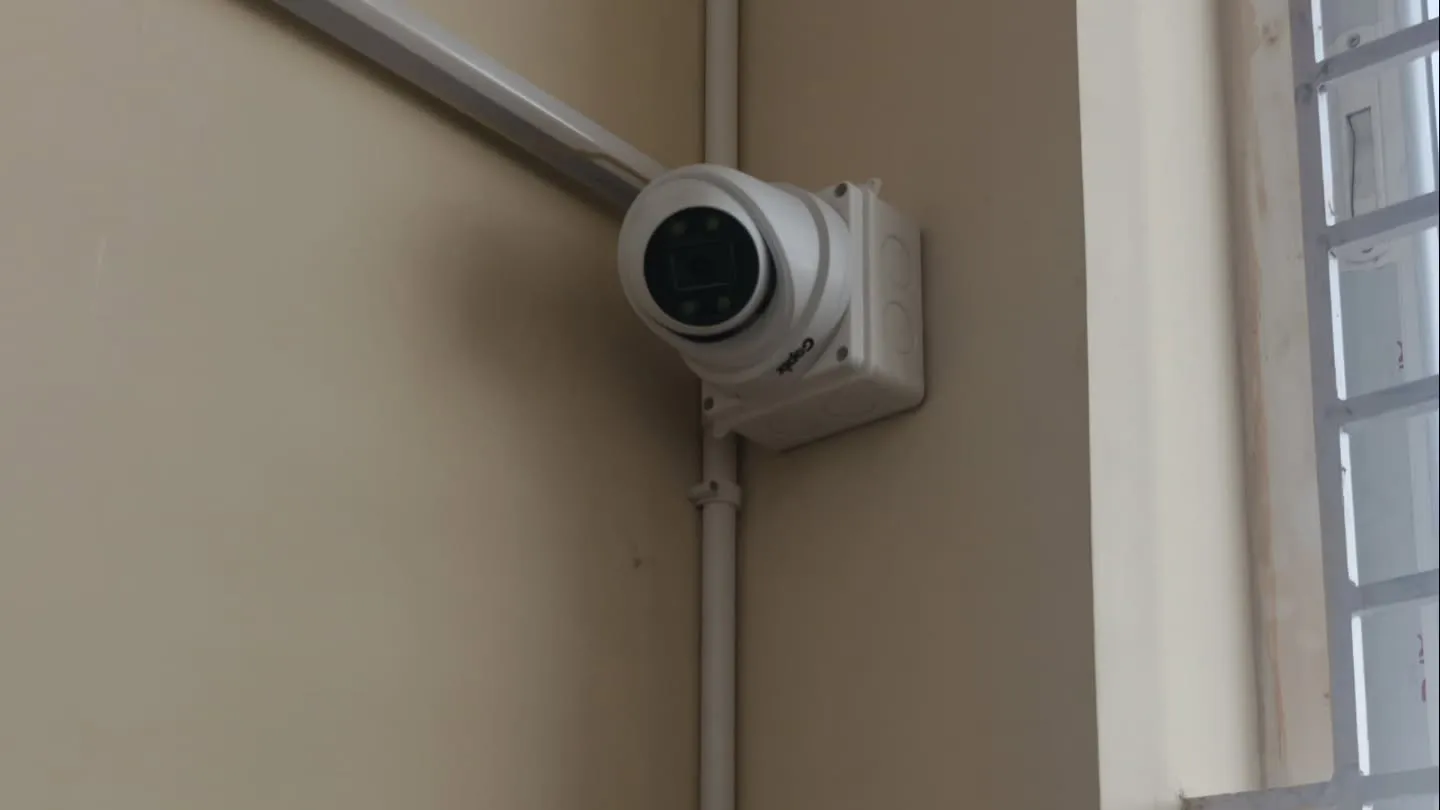 ​A Gopix 5MP S Series dome camera neatly installed with a waterproof junction box and matching white PVC surface casing along the interior wall.