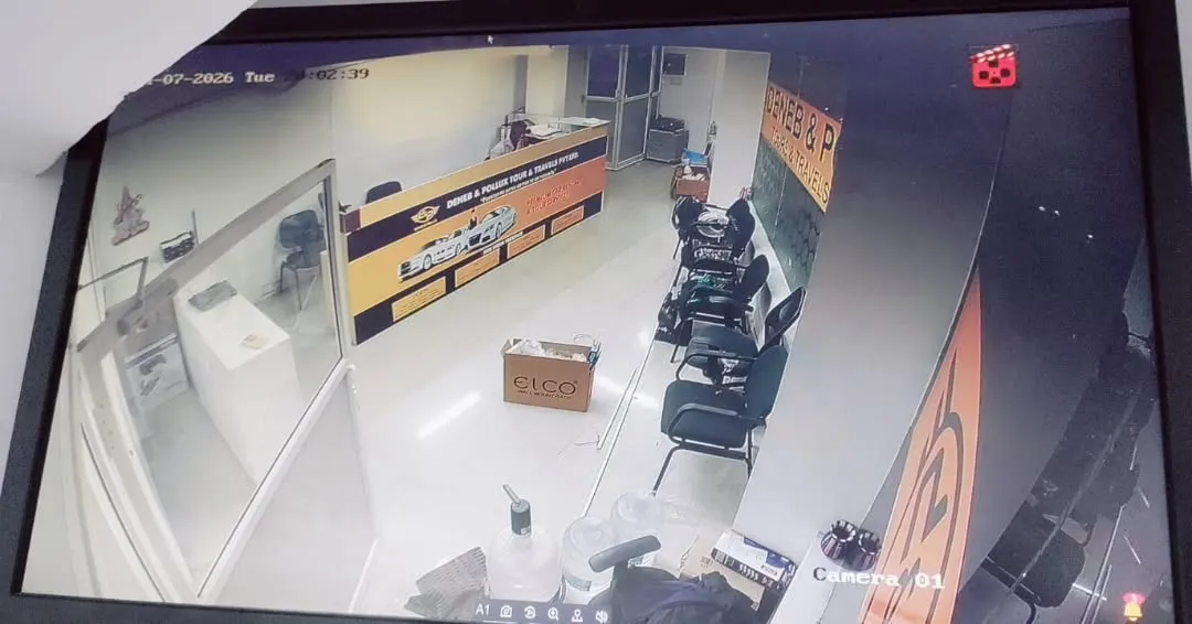 A monitor showing a sharp, high-definition live view from a Hikvision 5MP dome camera capturing the main reception desk and entrance lobby area of an office.